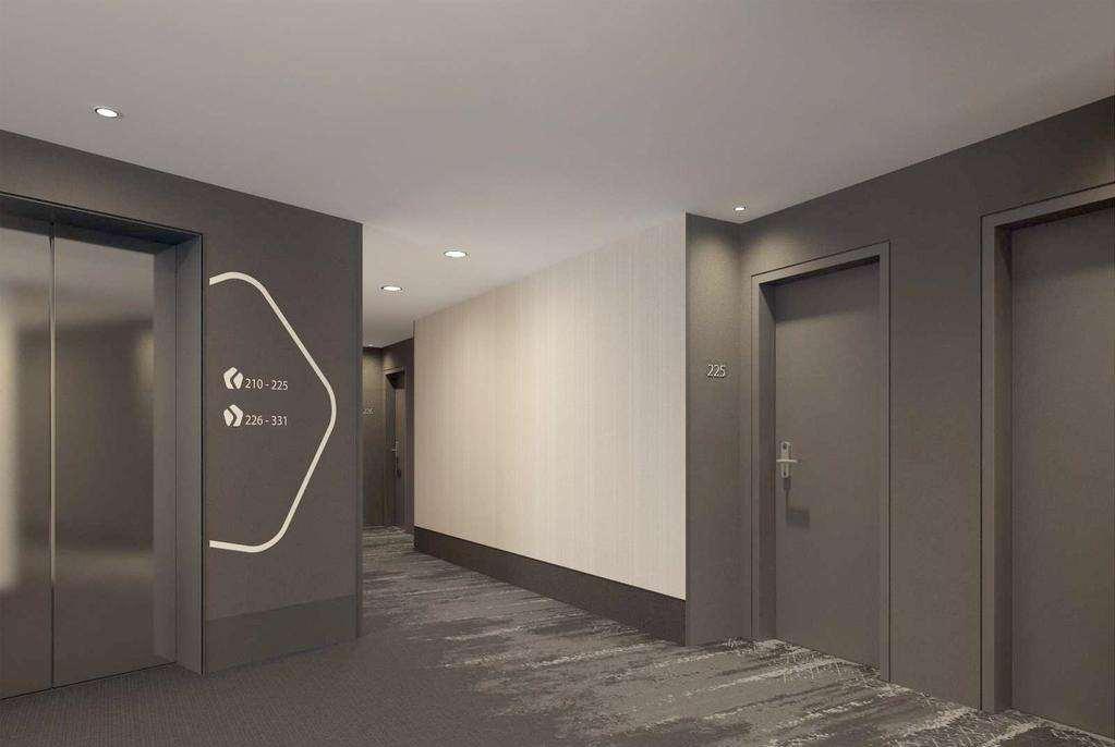 Hyperion Hotel Muenchen Интерьер фото The photo shows a modern hotel corridor. On the left side, there is an elevator with a sleek design, and next to it are wall graphics or signage. The corridor has a neutral color scheme, primarily gray with a light beige wall. Doors to guest rooms ar